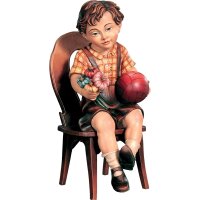 Sitting boy with ball and chair