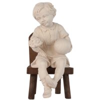 Sitting boy with ball and chair