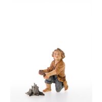 Child kneeling with fireplace