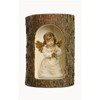 Bell angel praying in a tree trunk