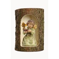 Bell angel with candle-carrier in a tree trunk