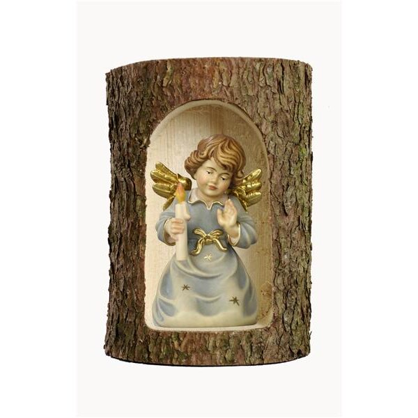 Bell angel with candle in a tree trunk