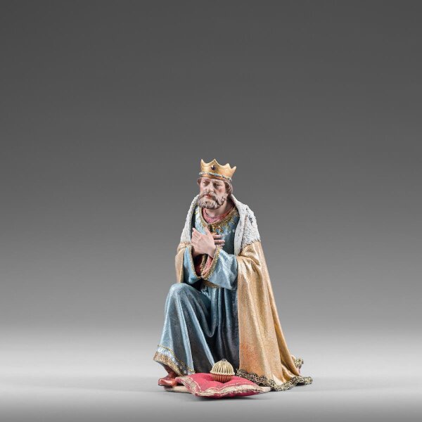 King kneeling with crown